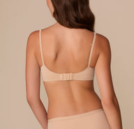 Back view of Alexis showing the Base Wirefree T-Shirt Bra in Beige. The image highlights the hook-and-eye closure and fully adjustable straps for a customizable fit.