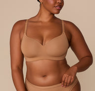 Front view of Zarria wearing the Base Wirefree T-Shirt Bra in Tan. The image highlights the bra’s lightly lined cups, V-neckline, and soft microfiber fabric. sizing: Zarria wears size 38D