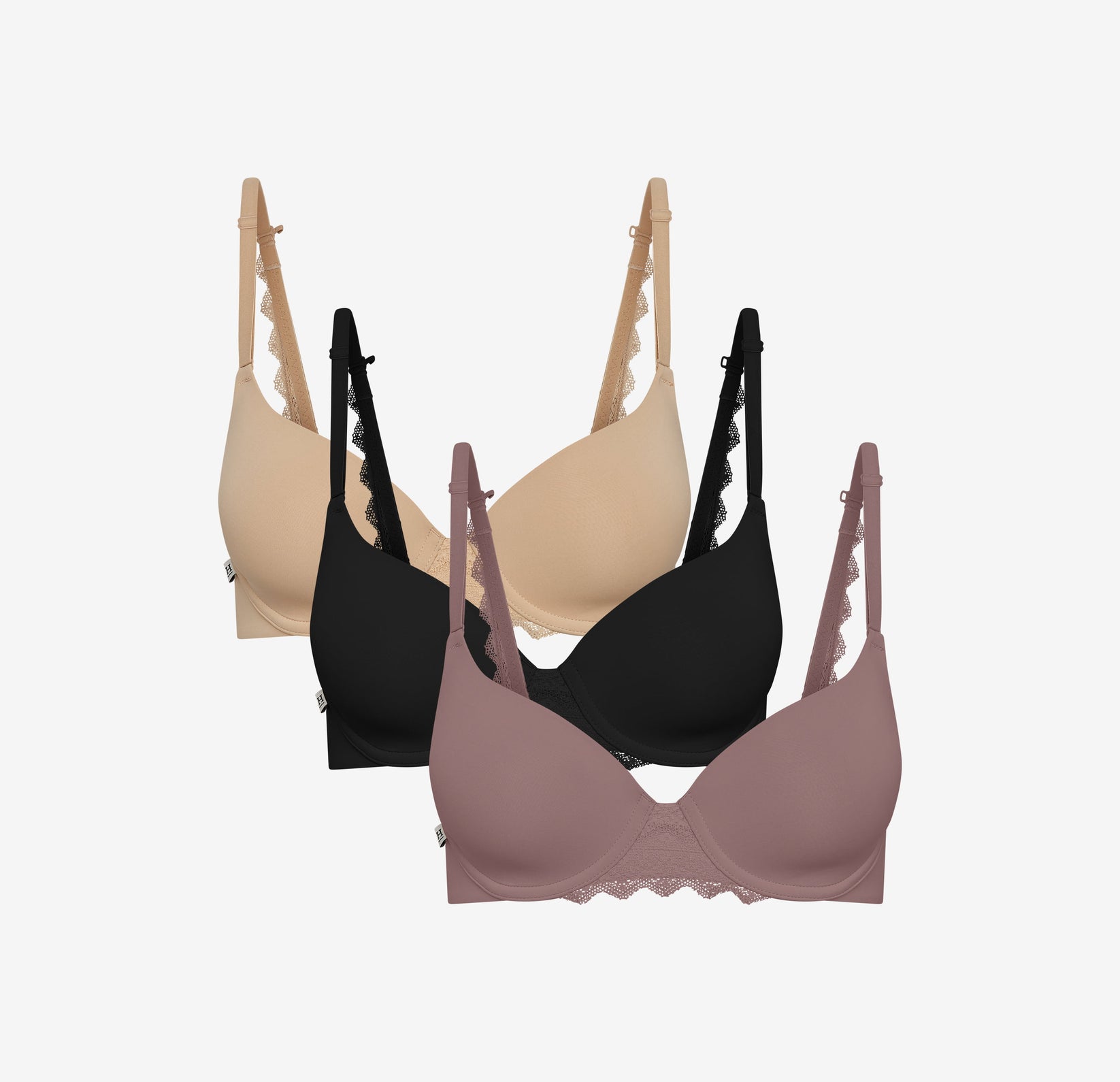 Harper Wilde Base Lace T-Shirt Bra in beige, black, and mauve, shown in a staggered front-facing display to highlight lace strap and band detailing on each color.