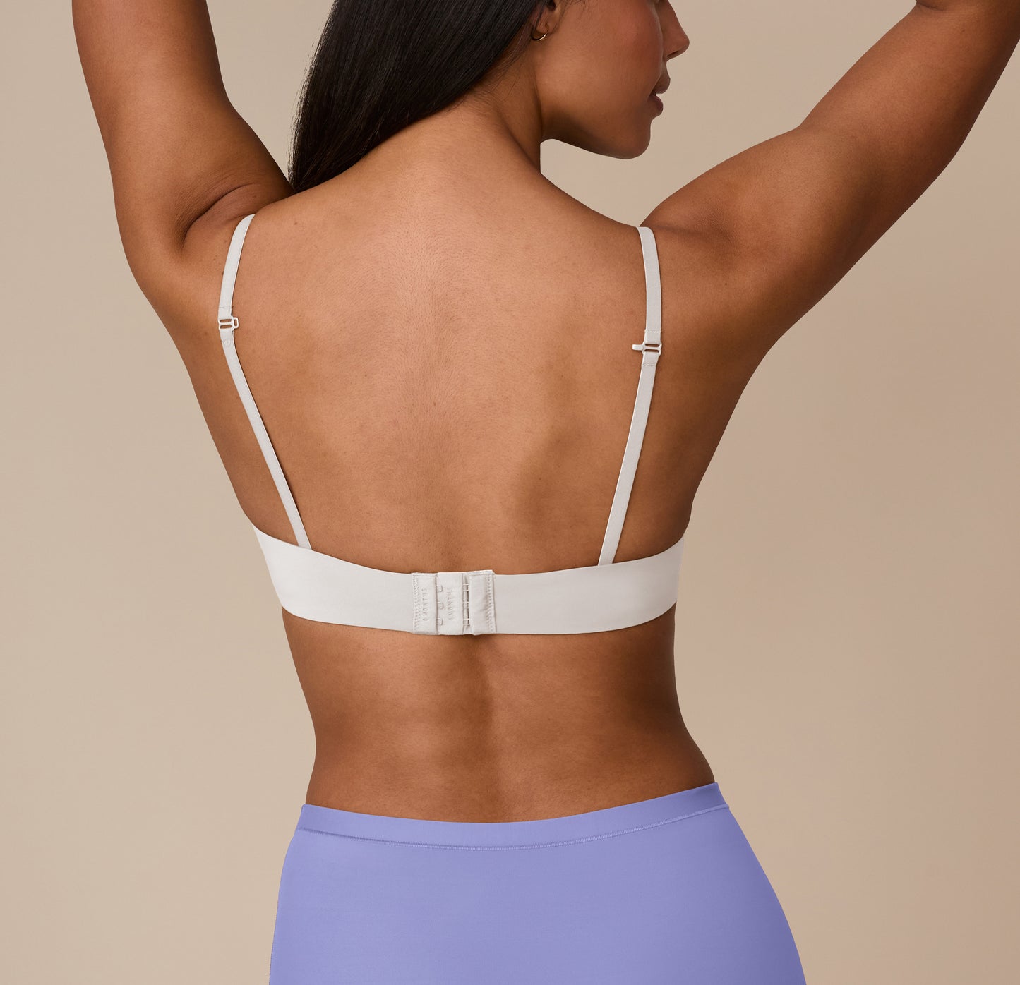 Back view showing J-Hook adjustable straps and a hook-and-eye closure on the Base T-Shirt Bra in Frost. A clean, supportive silhouette that stays put.
