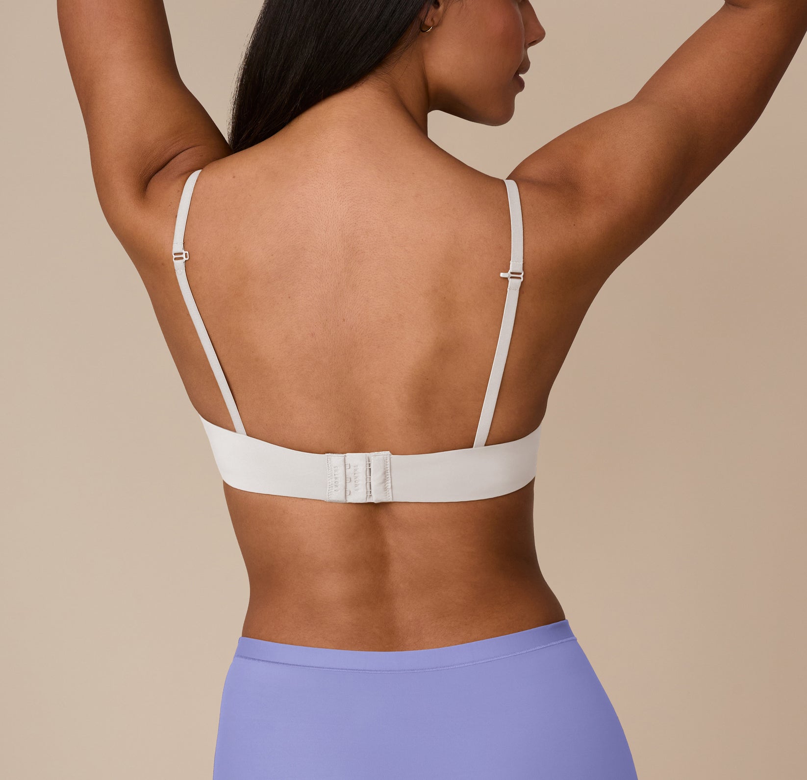 Back view showing J-Hook adjustable straps and a hook-and-eye closure on the Base T-Shirt Bra in Frost. A clean, supportive silhouette that stays put.