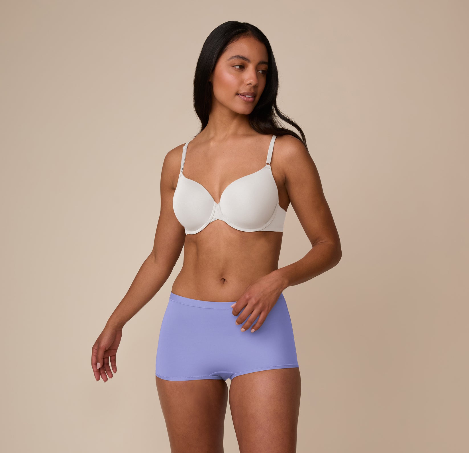 Full-body shot of Nemesis in motion, showcasing the comfortable, everyday fit of the Base T-Shirt Bra in Frost and Bliss Boyshort in Dusk.