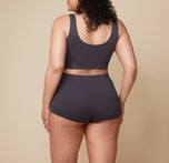 A back view of Bianca in the Lounge Boyshort, showcasing the full coverage of the boyshort in Charcoal.