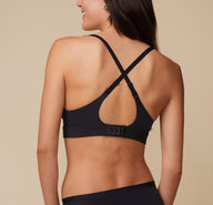 Anna wearing the Bliss Plunge Adjustable Bralette and Bliss Bikini, showing the bralette’s back in a racerback configuration.