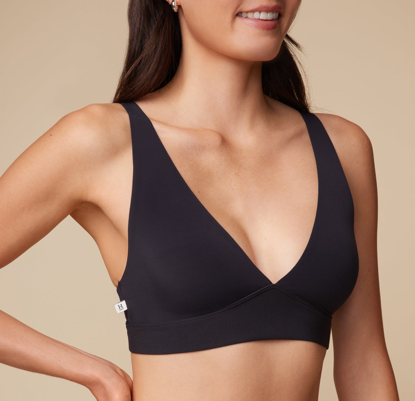 Close-up of Anna wearing the Bliss Plunge Adjustable Bralette in Black, showing the plunge neckline detail.