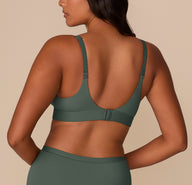Back view of Victoria in the Bliss Plunge Adjustable Bralette in Fir, highlighting adjustable straps and hook closure.