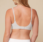 Rear view of Megan wearing the Bliss Plunge Adjustable Bralette in Frost. Adjustable straps and a hook-and-eye closure provide a customizable fit and light support.
