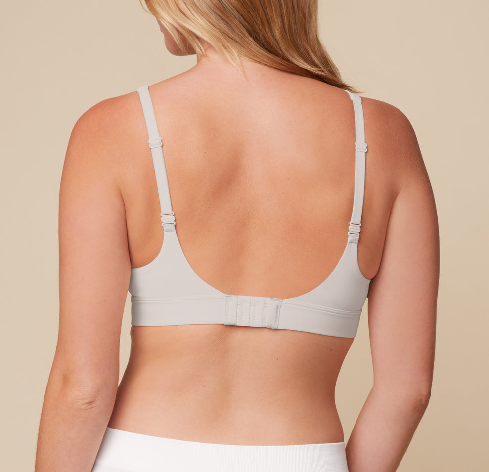 Rear view of Megan wearing the Bliss Plunge Adjustable Bralette in Frost. Adjustable straps and a hook-and-eye closure provide a customizable fit and light support.