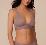 Close-up of Marcela wearing the Bliss Plunge Adjustable Bralette in Mauve. The image highlights the deep V-neckline and smooth, wireless cups in soft microfiber. sizing: Marcela wears size Small