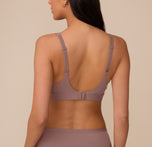 Rear view of Marcela wearing the Bliss Plunge Adjustable Bralette in Mauve. The adjustable straps and hook-and-eye closure provide customizable support.