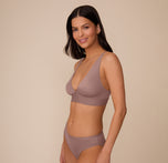 Side profile of Marcela in the Bliss Plunge Adjustable Bralette and matching Bliss underwear in Mauve. The image shows the plunging neckline and wide straps.