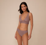 Full-body shot of Marcela wearing the Bliss Plunge Adjustable Bralette and matching Bliss underwear in Mauve. The look emphasizes the smooth fit and everyday comfort.