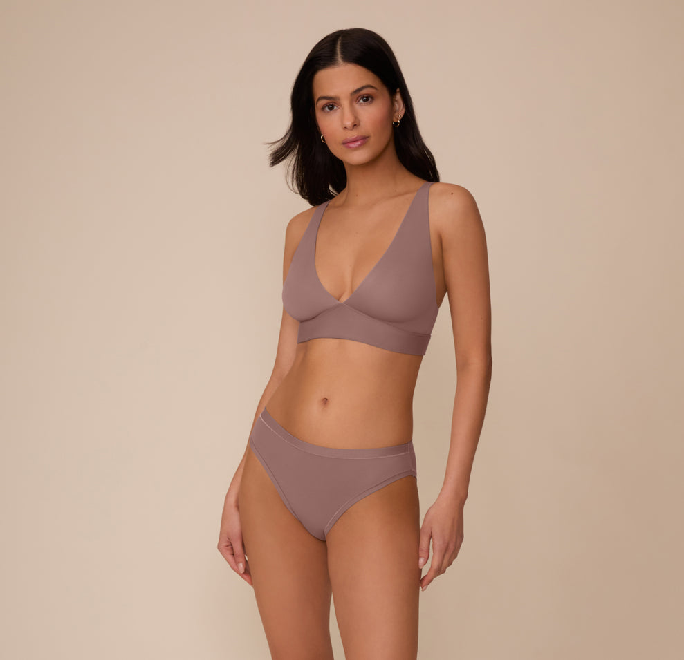 Full-body shot of Marcela wearing the Bliss Plunge Adjustable Bralette and matching Bliss underwear in Mauve. The look emphasizes the smooth fit and everyday comfort.