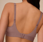Close-up of the back band and straps of the Bliss Plunge Adjustable Bralette in Mauve on Marcela. The smooth microfiber fabric and hook closure are visible.