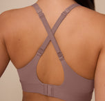 Back close-up of Marcela wearing the Bliss Plunge Adjustable Bralette in Mauve with straps converted into a cross-back style, showing the versatile strap adjustment.