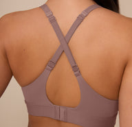 Back close-up of Marcela wearing the Bliss Plunge Adjustable Bralette in Mauve with straps converted into a cross-back style, showing the versatile strap adjustment.