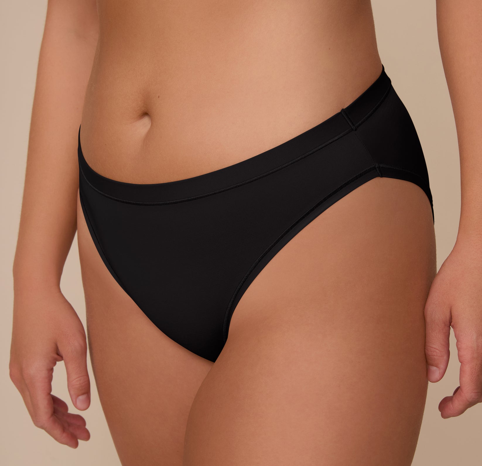 Close-up angled view of the Bliss Bikini in Black on Sonnie. The fabric’s soft stretch and clean lines highlight its seamless, second-skin feel and full front coverage.