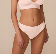 Close-up of Marcela wearing the Bliss Bikini in Rose, shown from the front. The bikini features a wide, smooth waistband that sits comfortably at the hips. sizing: Marcela wears a size Small