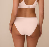 Back view of Marcela in the Bliss Bikini in Rose. The image highlights the moderate rear coverage and soft, stretchy fabric that moves with the body.