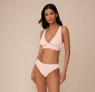 Full front view of Marcela wearing the Bliss Bikini and Bliss Triangle Bralette in Rose. The set highlights the sleek design and ultra-soft microfiber fabric.