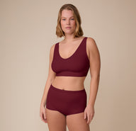 Sonnie wearing the Bliss Boyshort and matching Bliss Bralette in Bordeaux. She stands confidently, showing the full coordinated set.