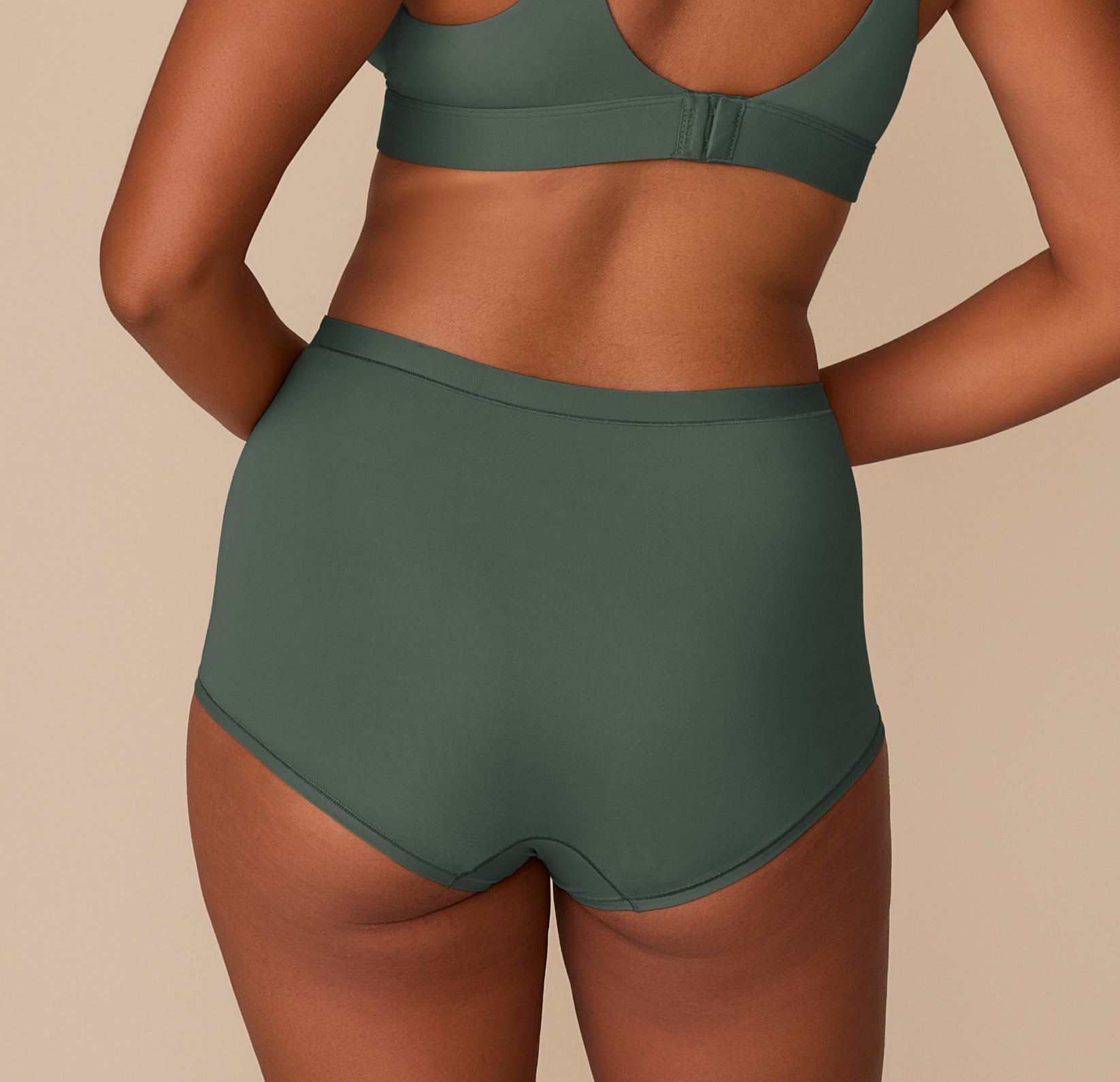 Back view of Victoria in the Bliss Boyshort in Fir, highlighting the full coverage and seamless finish.