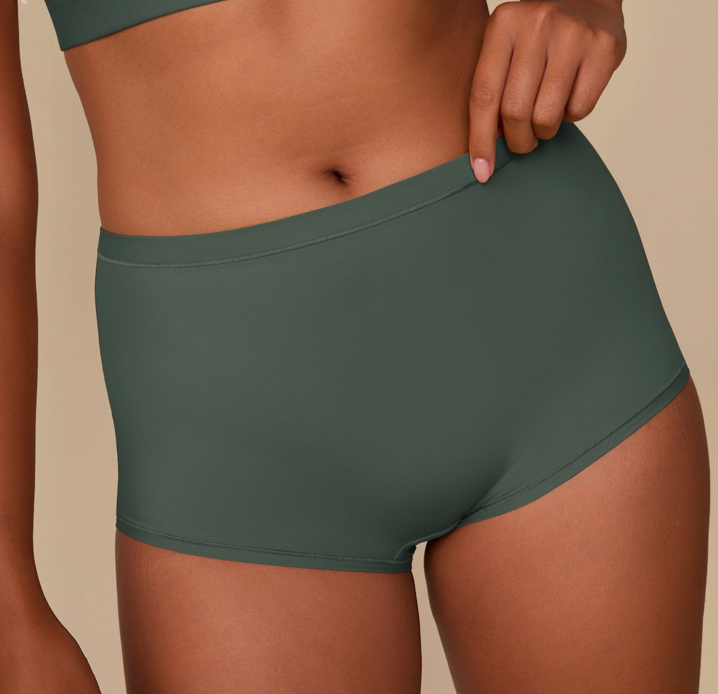 Close up shot of Victoria in the Bliss Boyshort in Fir. The minimal seams and smooth, comfortable fabric are emphasized.