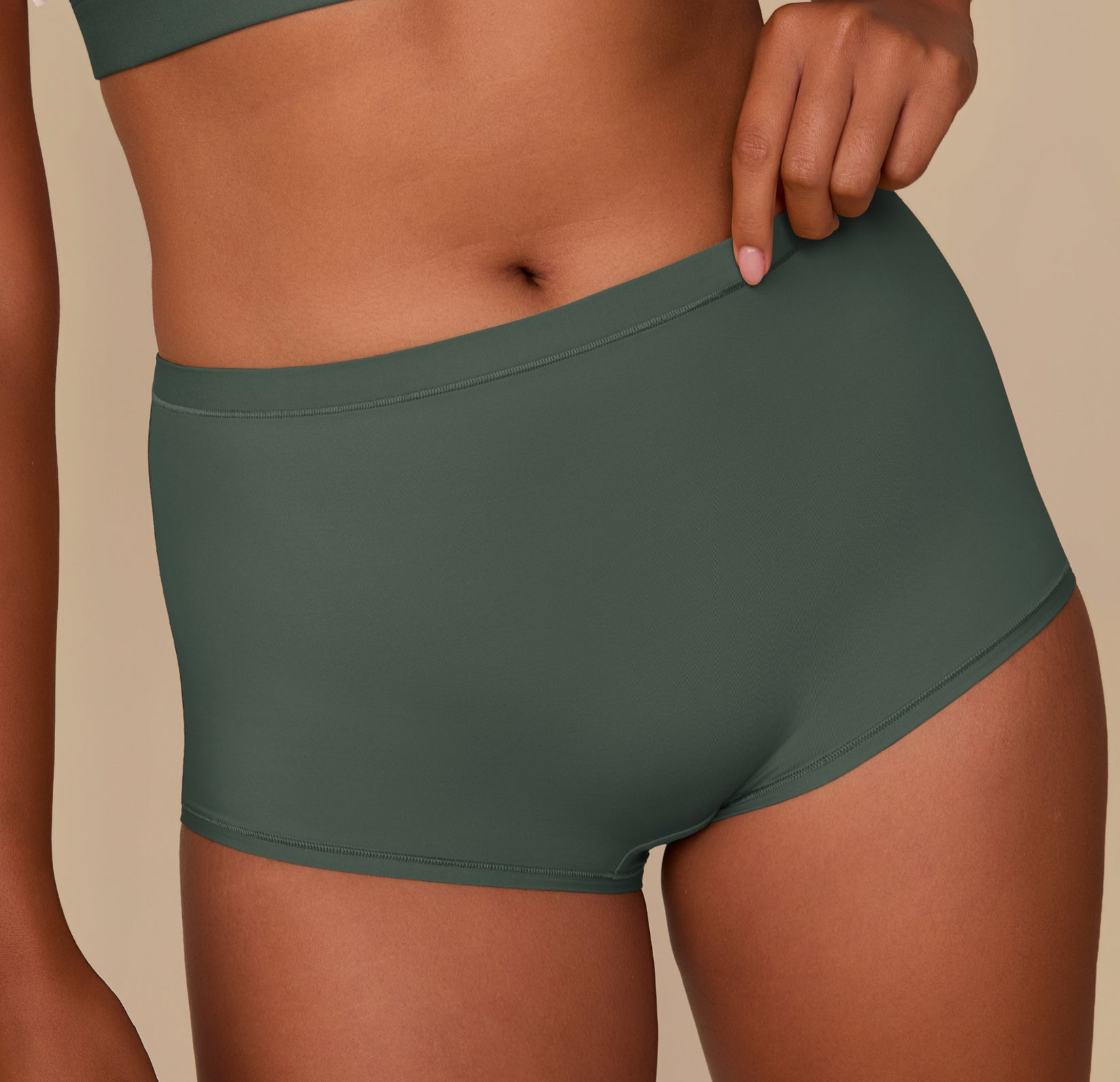 Close up shot of Victoria in the Bliss Boyshort in Fir. The minimal seams and smooth, comfortable fabric are emphasized.