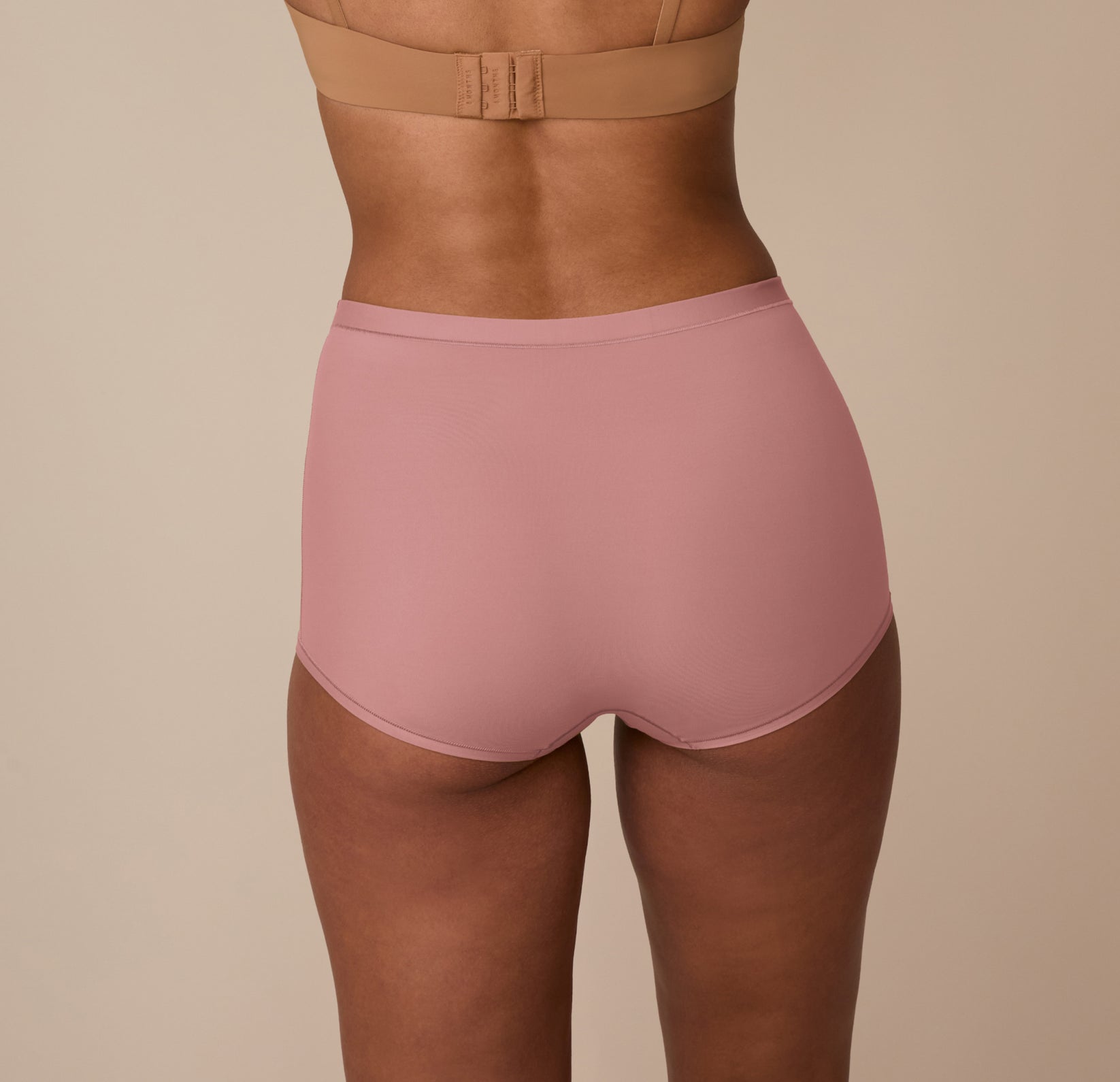 Back view of Marcela in the Bliss Boyshort in Plum, highlighting the full-coverage fit and soft, elastic-free waistband for everyday comfort.