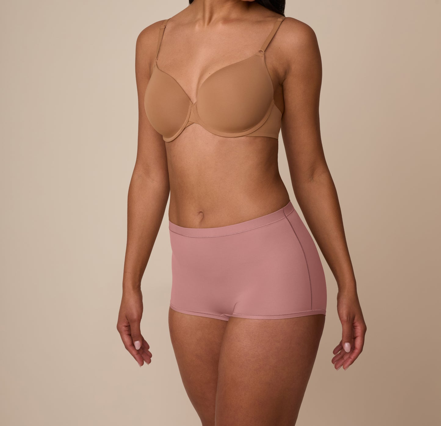 Side angle of Marcela wearing the Bliss Boyshort in Plum, showing the stretchy microfiber fabric and stay-in-place design.