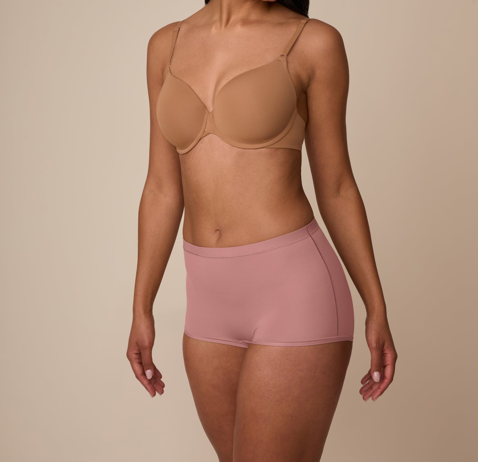 Side angle of Marcela wearing the Bliss Boyshort in Plum, showing the stretchy microfiber fabric and stay-in-place design.