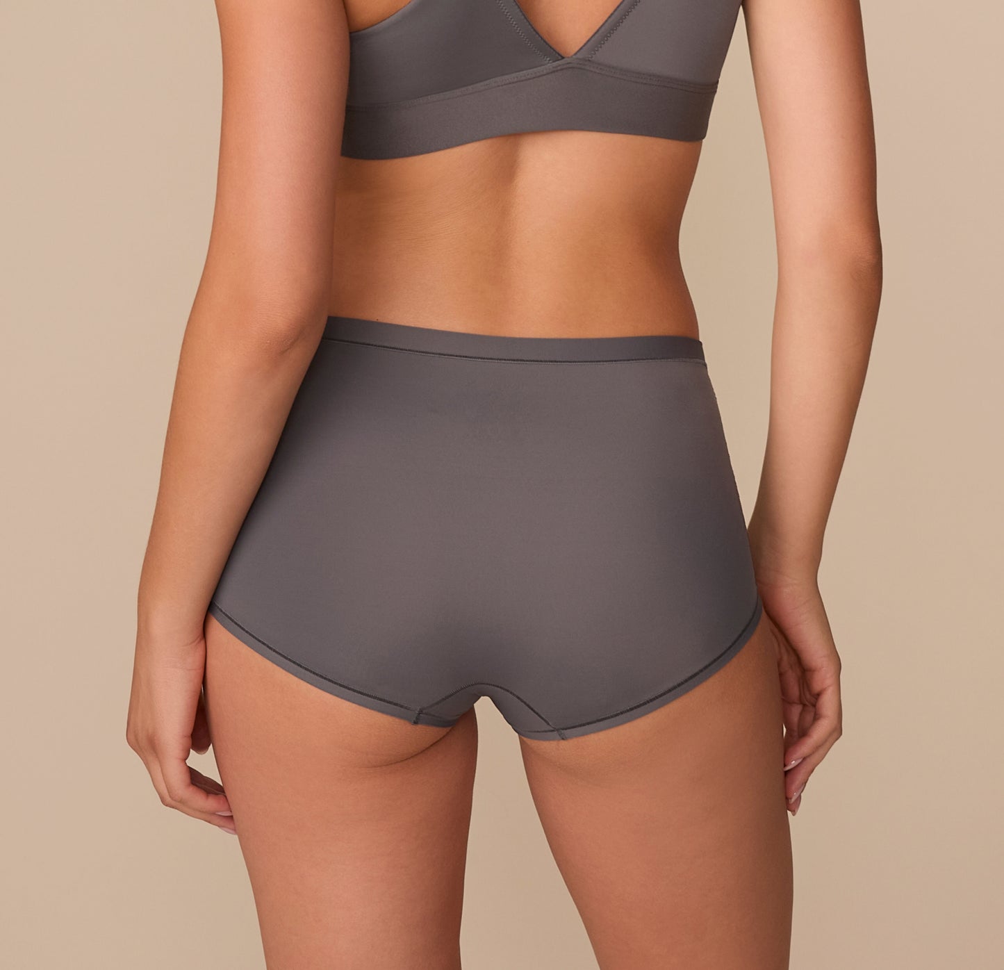 Back view of Alexis in the Bliss Boyshort in Smoke, highlighting the full-coverage design and clean lines.