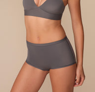 Side view of Alexis modeling the Bliss Boyshort in Smoke, emphasizing the curve-hugging silhouette and stretch fabric.