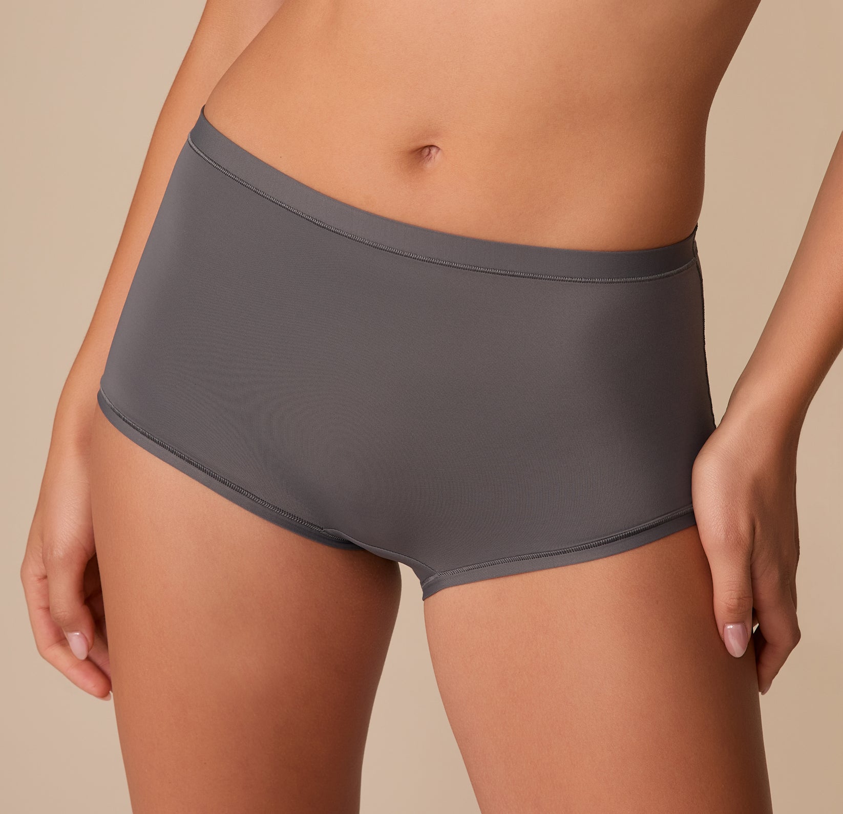 Extreme close-up of the Bliss Boyshort in Smoke on Alexis, focusing on the soft waistband and smooth finish around the hips.