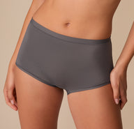 Extreme close-up of the Bliss Boyshort in Smoke on Alexis, focusing on the soft waistband and smooth finish around the hips.