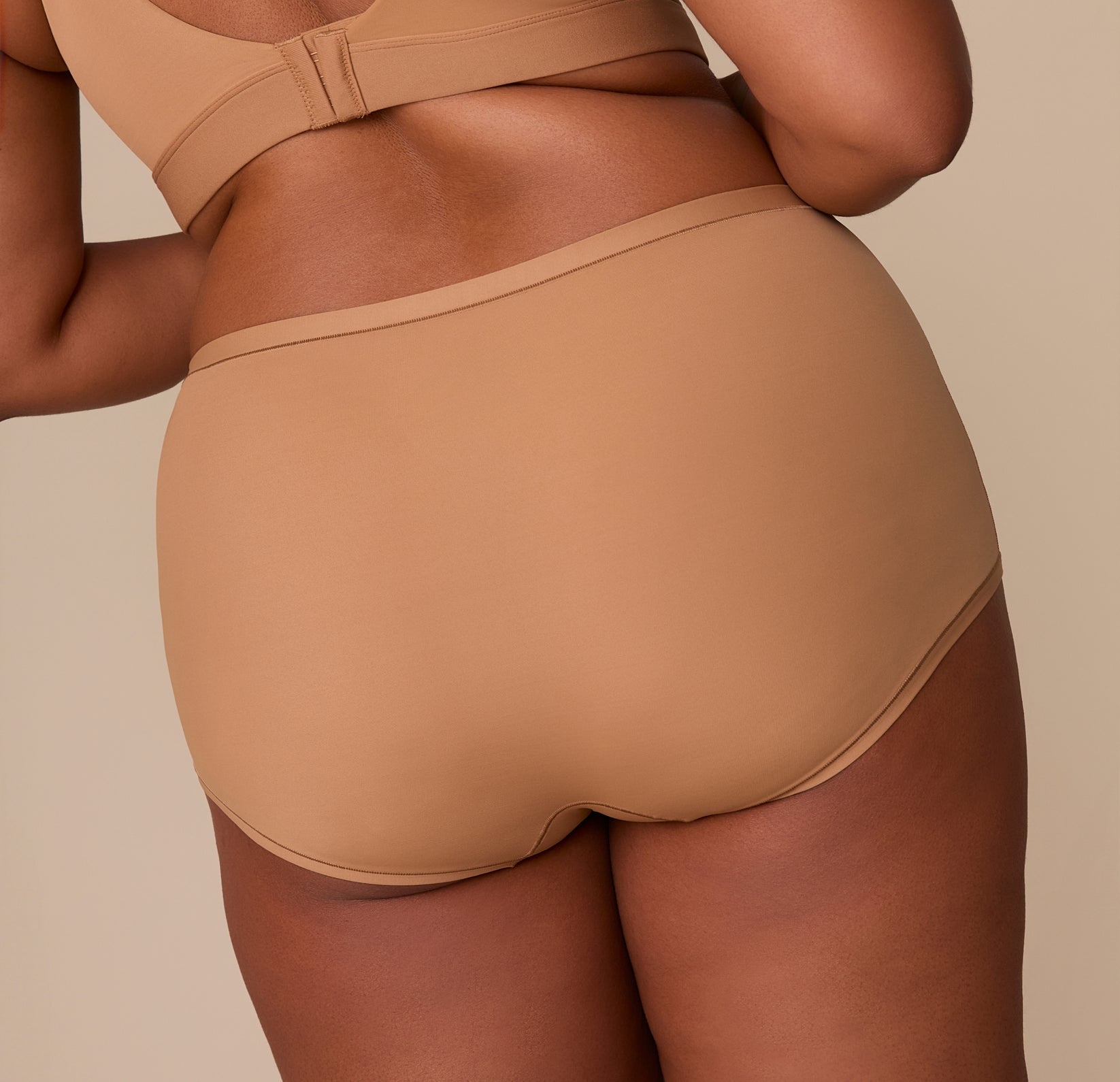 Close-up of the back of the Bliss Boyshort in Tan on Zarria. The image focuses on the full coverage fit and seamless appearance under clothing.