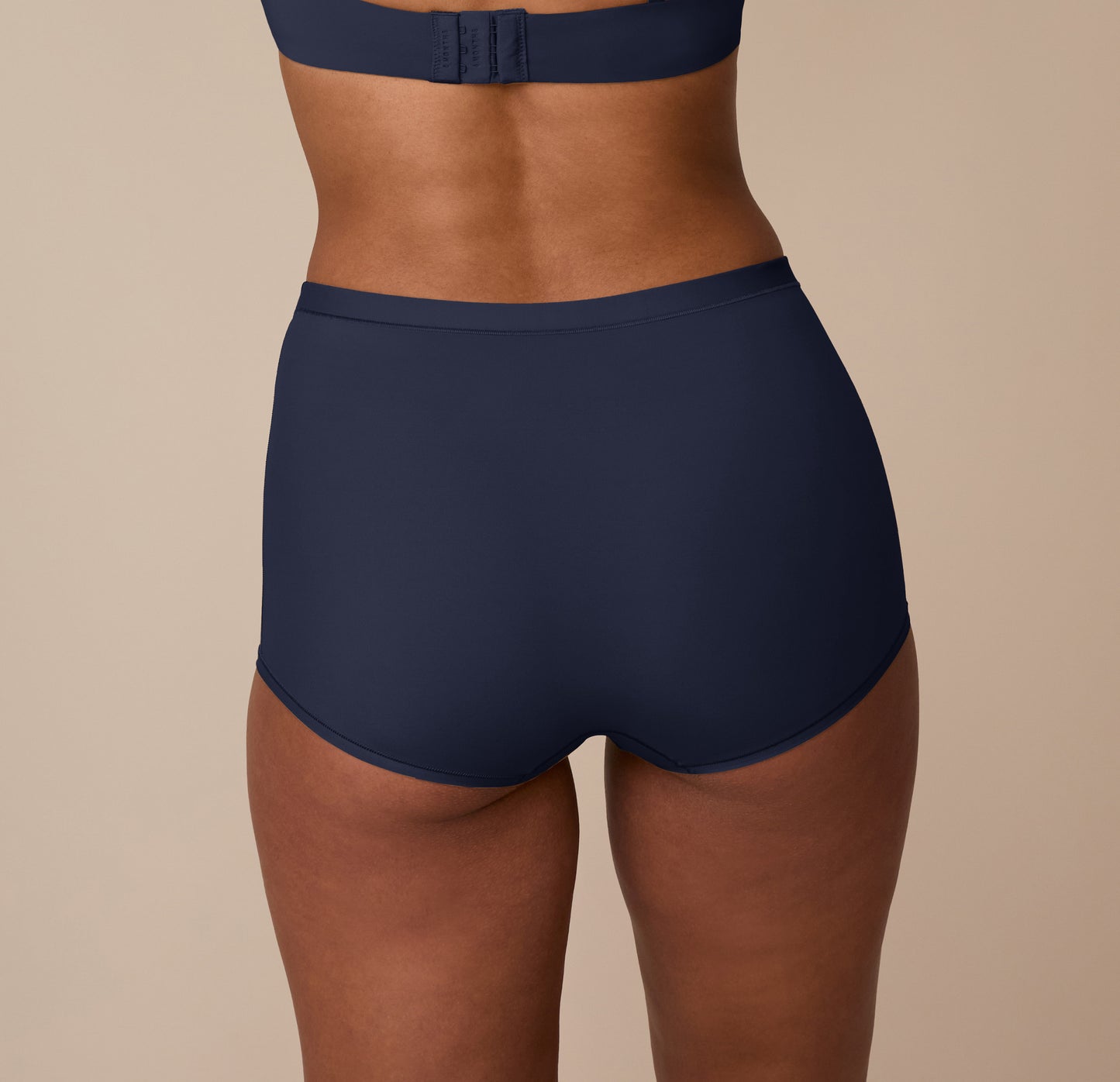 Back view of the Bliss Boyshort in True Blue on Nemesis, showing the smooth waistband and no-dig leg openings for maximum comfort.