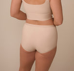 A rear view of Sonnie modeling the Bliss Boyshort in Beige, showcasing the smooth, no-dig waistband and full-coverage design that provides a secure, stay-put fit.