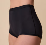 A three-quarter side view of Gracie modeling the Bliss Boyshort, highlighting its detailed construction and flexible fabric.