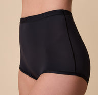 A three-quarter side view of Gracie modeling the Bliss Boyshort, highlighting its detailed construction and flexible fabric.