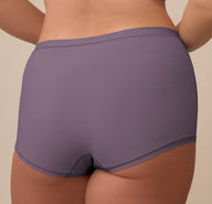 Back close-up of the Bliss Boyshort in Eclipse worn by Sonnie. The image highlights the full-coverage design, clean stitching, and soft stretch fabric in the muted Eclipse tone.