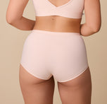 A rear view of Emersyn showcasing the full-coverage back of the Bliss Boyshort in Rose. The fabric lays flat, ensuring a no-show fit under clothing.