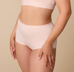 A three-quarter side view of Emersyn modeling the Bliss Boyshort, highlighting its comfortable, stretchy fabric and mid-thigh length.