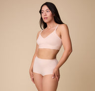 Emersyn wears the Bliss Boyshort in Rose paired with the matching Bliss Triangle Bralette, posing confidently against a neutral backdrop.