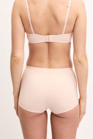 Megan wears the Bliss Boyshort in Rose from the back, showing the full coverage fit and smooth microfiber fabric.