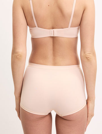 Megan wears the Bliss Boyshort in Rose from the back, showing the full coverage fit and smooth microfiber fabric.