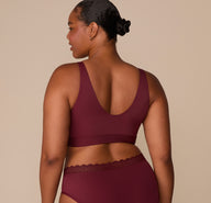 Back view of Zarria showing the seamless band and low scoop back of the Bliss Bralette in Bordeaux.