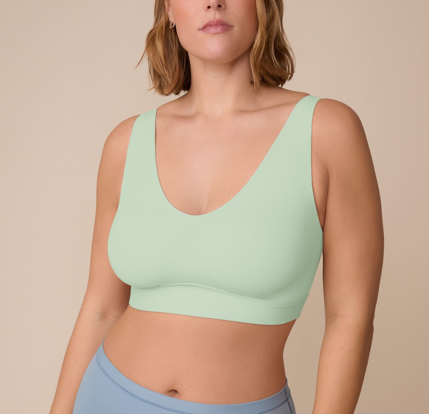 Close-up front view of Sonnie wearing the Bliss Bralette in Dew. The image highlights the deep V-neckline and smooth, ultra-soft microfiber fabric. sizing: Sonnie wears size XL