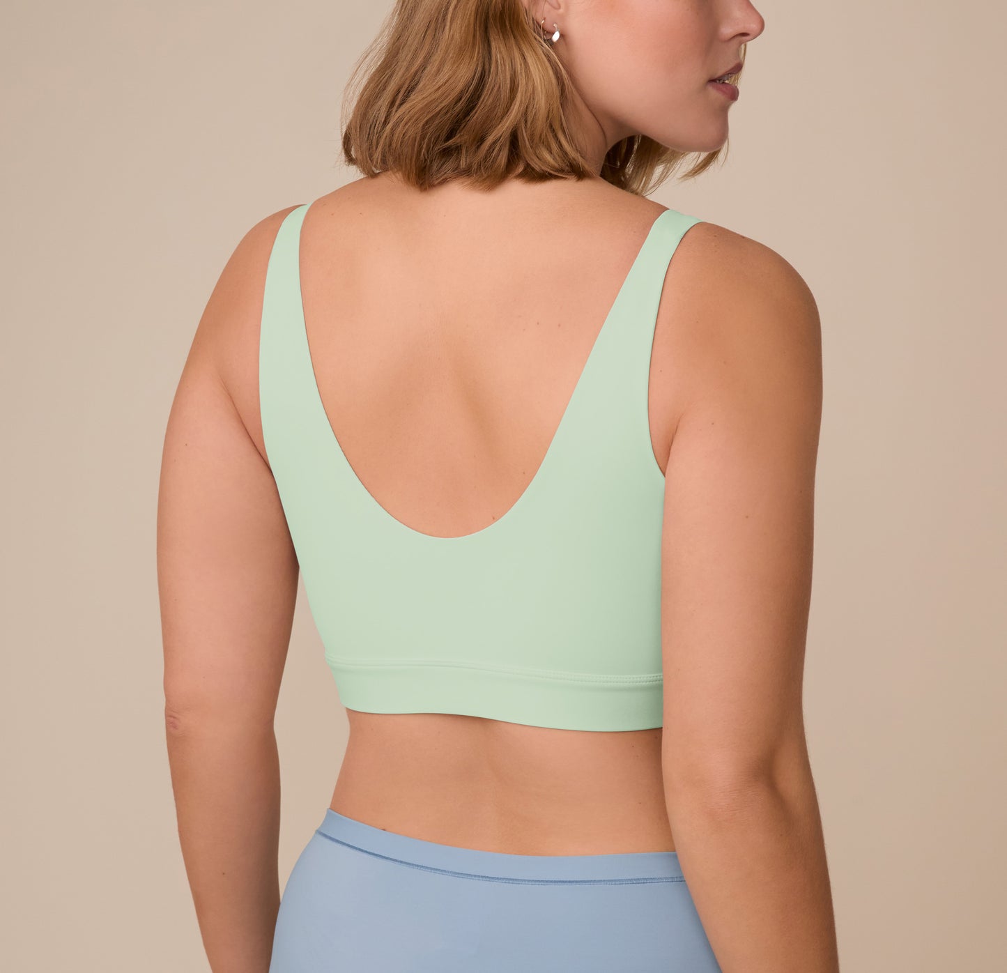 Back view of Sonnie in the Bliss Bralette in Dew, showing the wide straps and wireless band that offers lift without underwire.