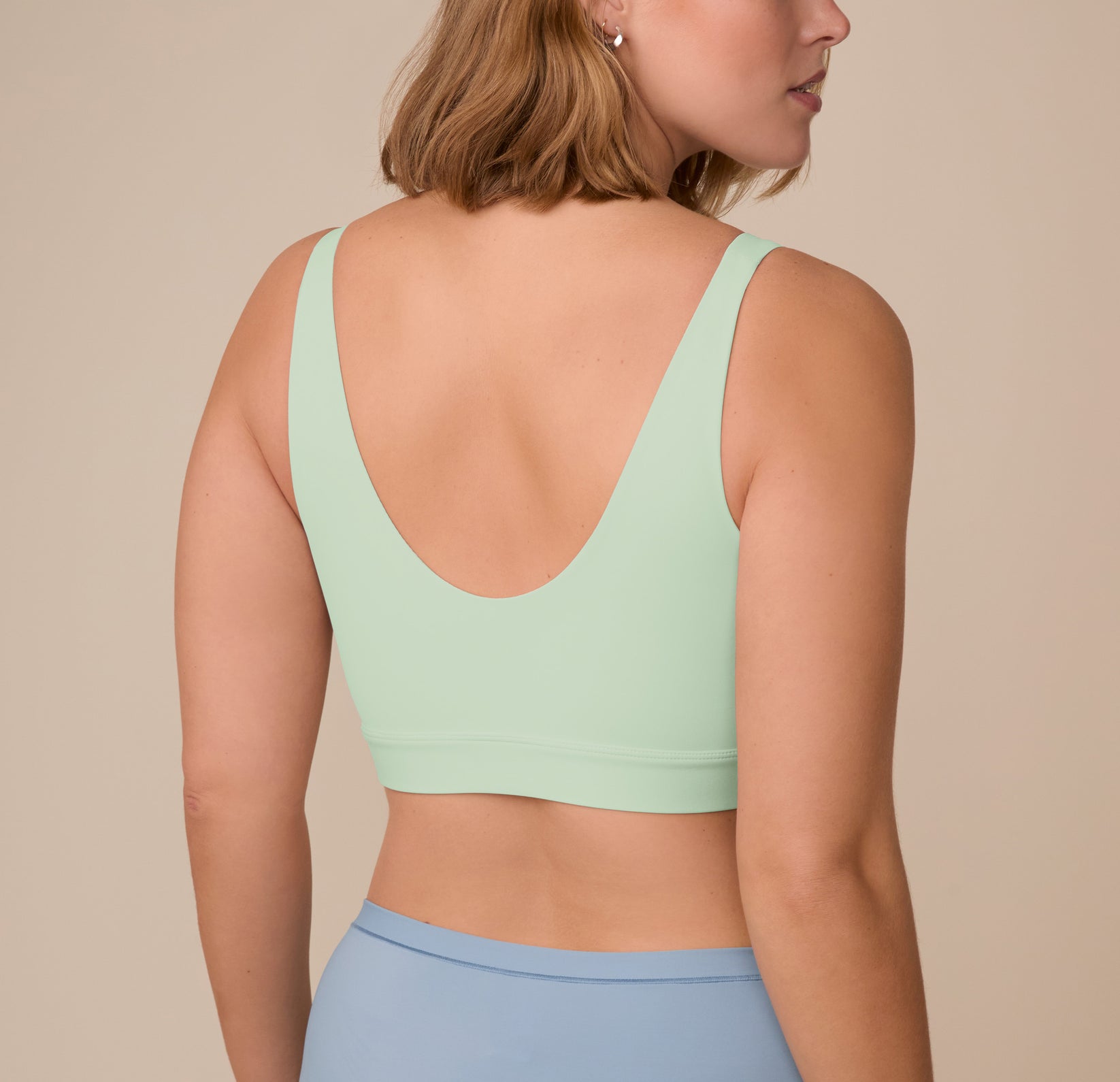 Back view of Sonnie in the Bliss Bralette in Dew, showing the wide straps and wireless band that offers lift without underwire.